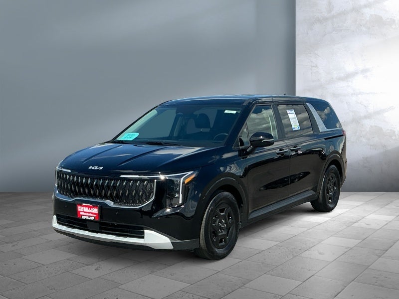 2026 Kia Carnival LXS in Aurora Black Pearl — front three-quarter view